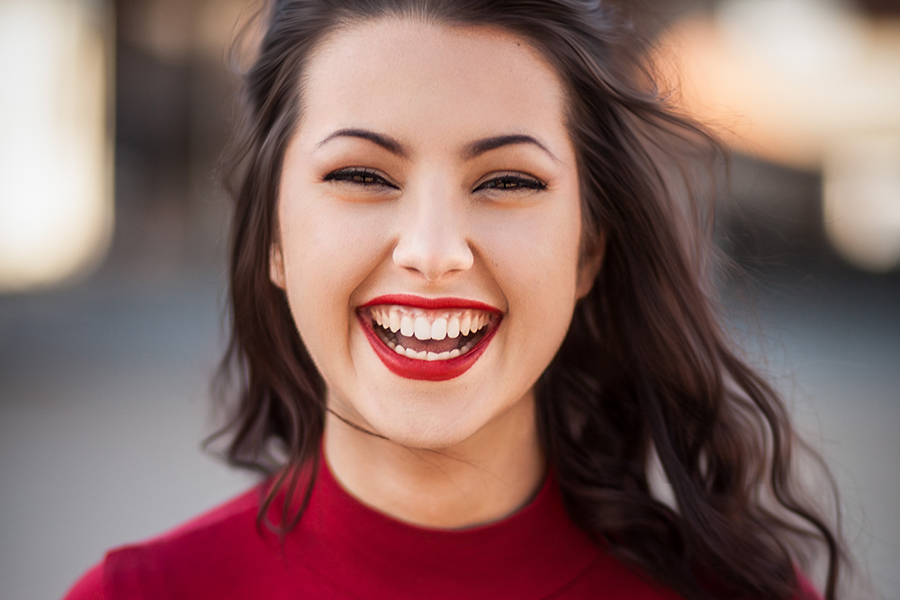 smiling woman happy after funding corporation tax bill