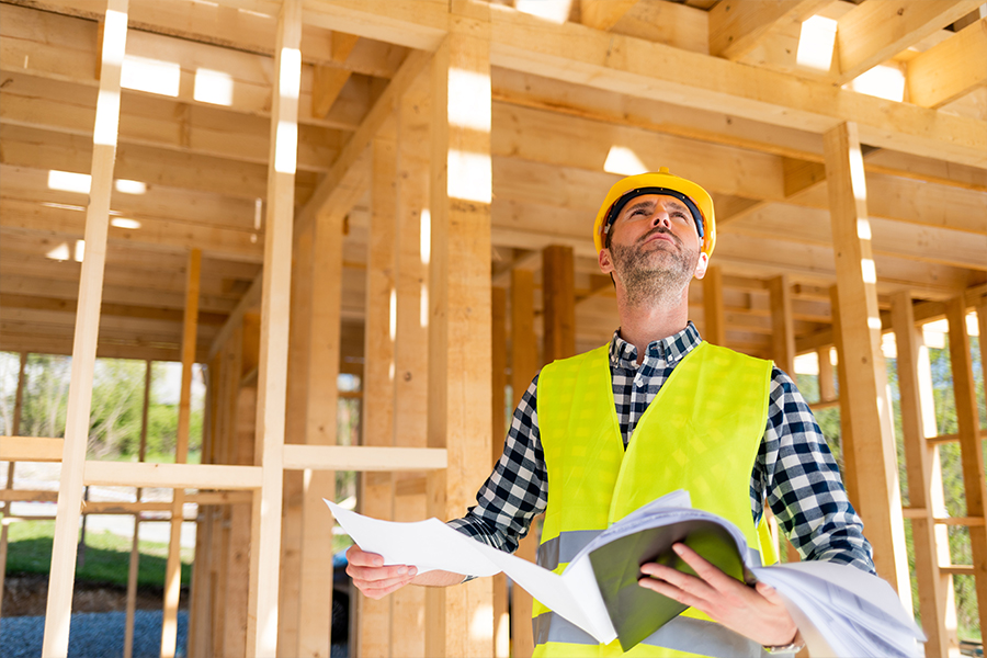 construction working checking plans to calculate Development costs